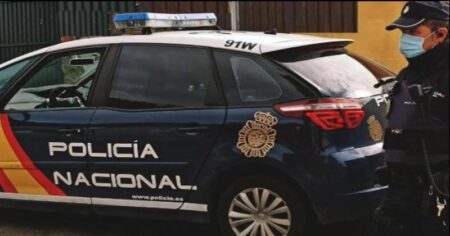 Spanish Police Disrupts Gang Manipulating Electronic Roulette Games Nationwide A Police Officer in Spain Stands Next to His Vehicle