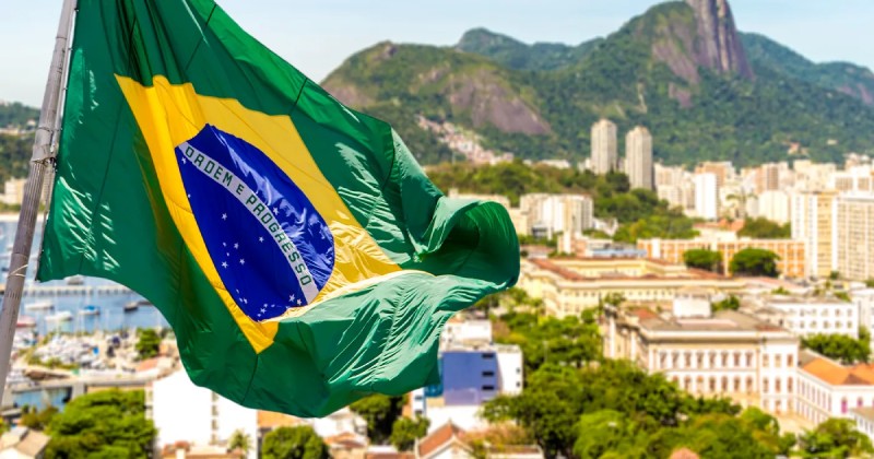 Brazils National Flag Waving Over Rio De Janeiro