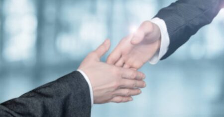 Two Businessmen Reaching For a Handshake